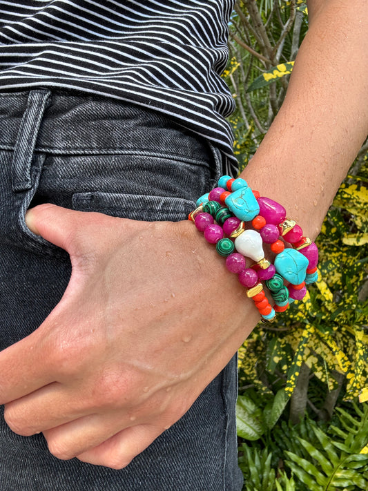 Colorful beaded bracelet on a wrist with a blurred natural background