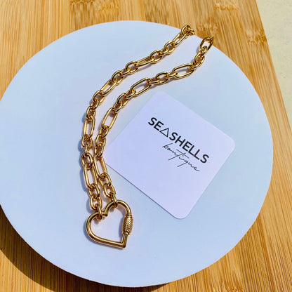 Chunky heart charm necklace styled for layering