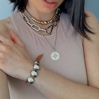 AVINZIA compass pendant in gold and silver tones