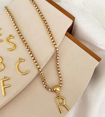 Initial letter necklace styled for layering