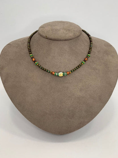 Green beaded necklace styled for layering