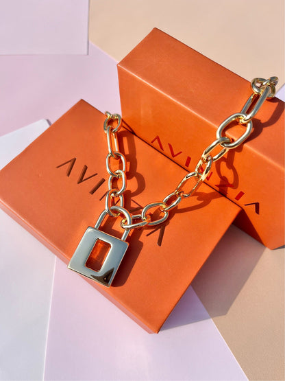 Gold lock chain worn layered