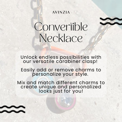 May include: A silver chain necklace with a carabiner clasp. The necklace is decorated with colorful charms, including a blue and white evil eye charm. The text on the image reads &#39;AVINZIA&#39;, &#39;Convertible Necklace&#39;, &#39;Unlock endless possibilities with our versatile carabiner clasp!&#39;, &#39;Easily add or remove charms to personalize your style.&#39;, &#39;Mix and match different charms to create unique and personalized looks just for you!&#39;