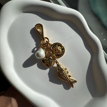 Lion and fish gold bag charm and keychain purse accessory by AVINZIA — handmade coastal jewelry
