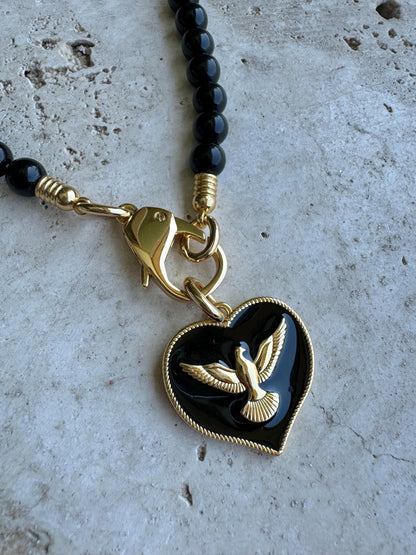 Black obsidian beaded necklace with cross charm and gold chain options by AVINZIA