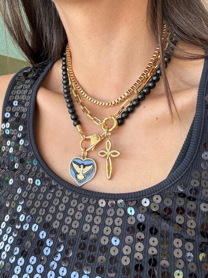 Black obsidian beaded necklace with cross charm and gold chain options — handmade in Florida by AVINZIA