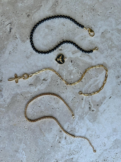 Black obsidian beaded necklace with cross charm and gold chain options — gift-ready handmade jewelry by AVINZIA