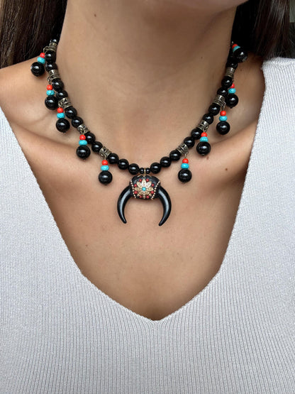 Black obsidian beaded necklace with crescent moon charm by AVINZIA — handmade coastal jewelry