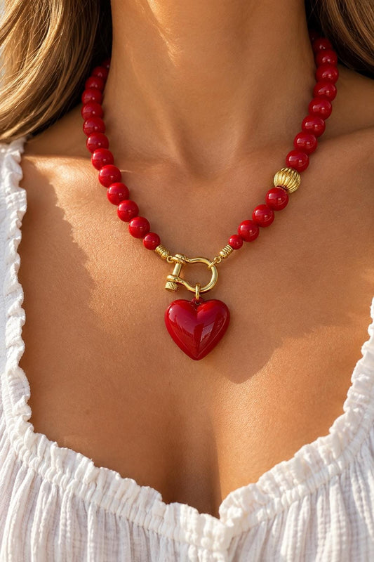 Red puffy enameled heart necklace by AVINZIA — beaded strand with gold horseshoe clasp